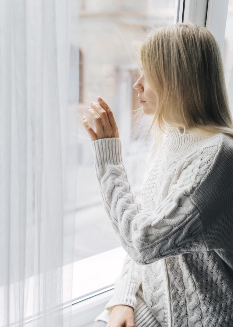 side-view-woman-home-pandemic-looking-through-window